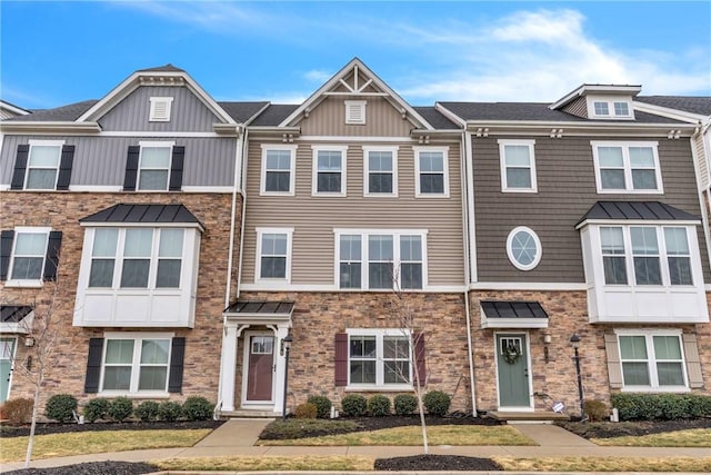 townhome / multi-family property featuring stone siding and board and batten siding