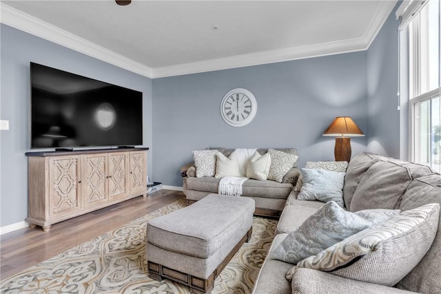 living area with ornamental molding, baseboards, and wood finished floors