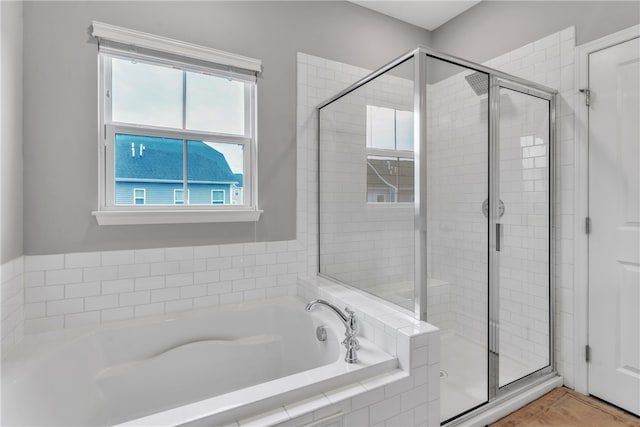 full bath featuring a stall shower, tile patterned flooring, and a garden tub