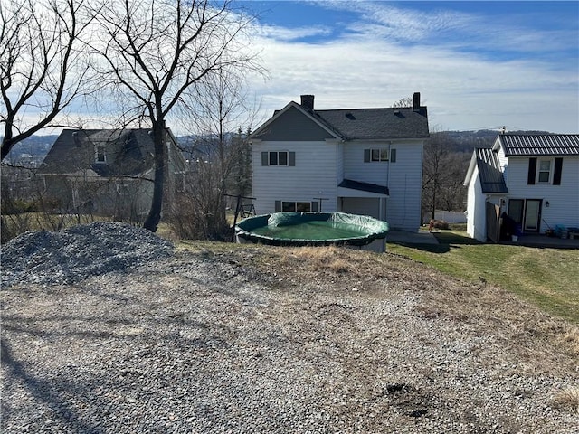 rear view of property with a chimney