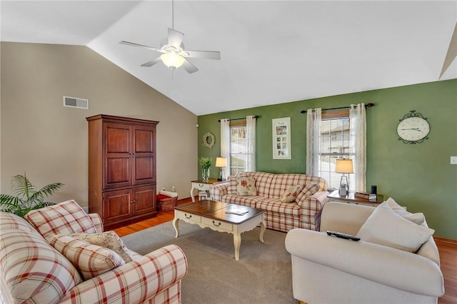 living area with high vaulted ceiling, visible vents, and ceiling fan