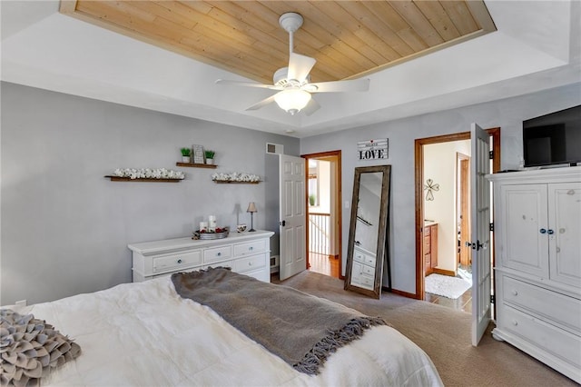 carpeted bedroom with wooden ceiling, a raised ceiling, a ceiling fan, and baseboards