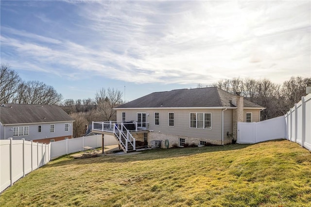 rear view of property featuring a fenced backyard, stairs, a deck, and a lawn