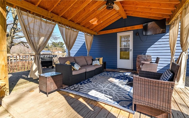 wooden terrace featuring a grill, an outdoor living space, and a ceiling fan