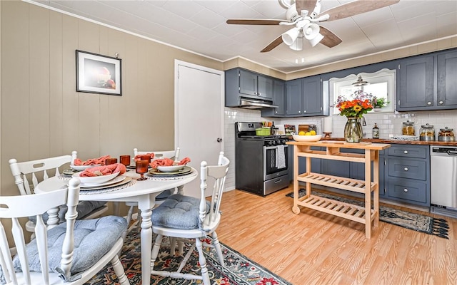 kitchen with under cabinet range hood, appliances with stainless steel finishes, light wood-type flooring, and decorative backsplash