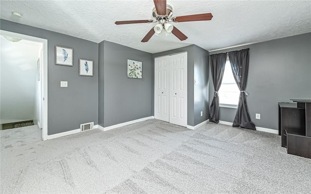 unfurnished bedroom featuring carpet floors, a closet, visible vents, and baseboards