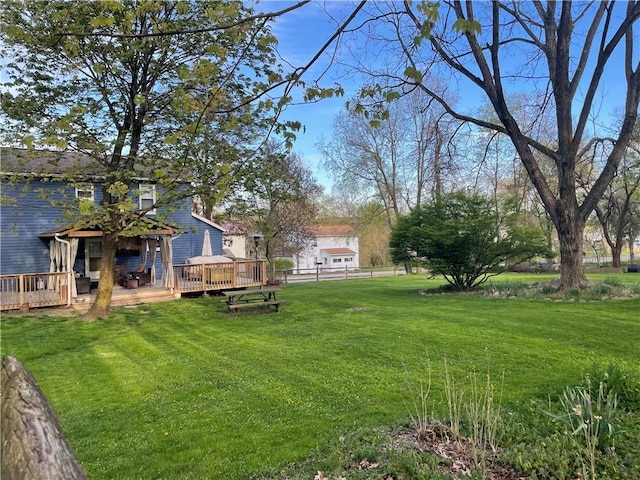 view of yard featuring a deck and fence