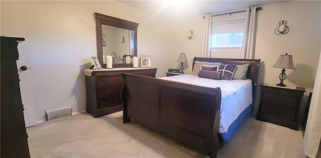 bedroom featuring light carpet and visible vents