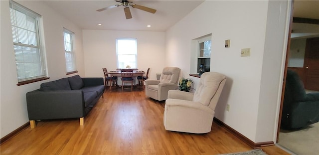 living room featuring light wood-style flooring, baseboards, ceiling fan, and recessed lighting