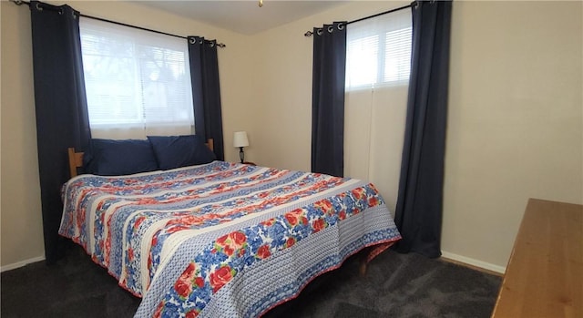 carpeted bedroom featuring baseboards