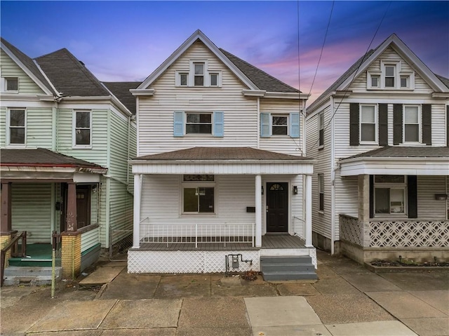 view of front of property featuring a porch and roof with shingles