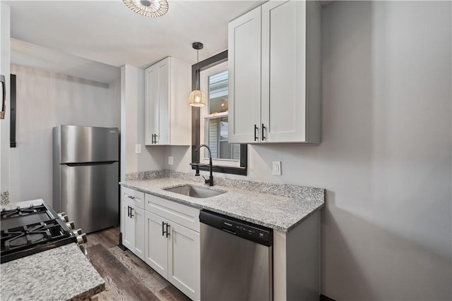 kitchen with white cabinetry, appliances with stainless steel finishes, dark wood-style flooring, and a sink