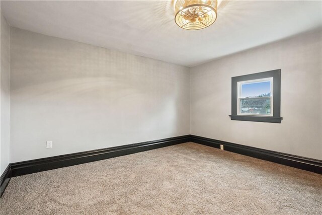 empty room with carpet floors and baseboards