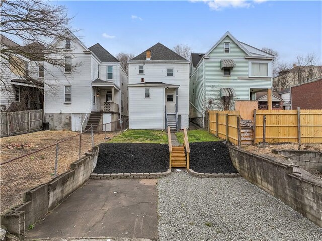 back of house featuring fence private yard