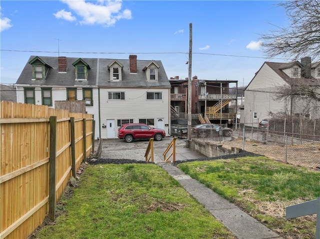 view of yard with a garage, stairway, and fence