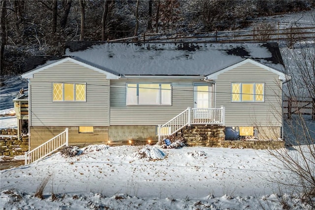 view of snow covered rear of property