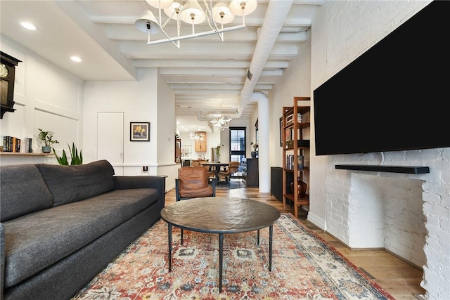 living room with recessed lighting, a fireplace, wood finished floors, and an inviting chandelier