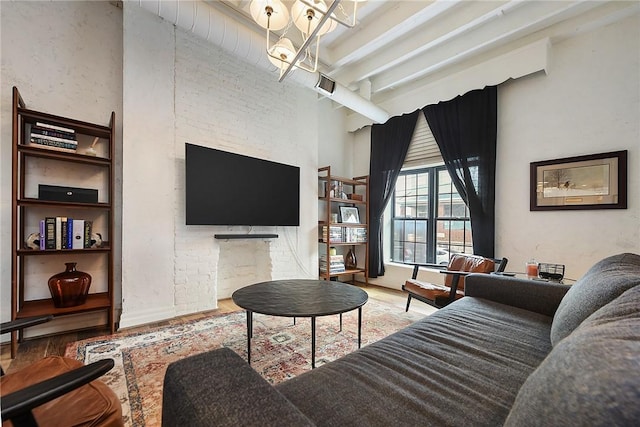 living room featuring an inviting chandelier, wood finished floors, and beamed ceiling