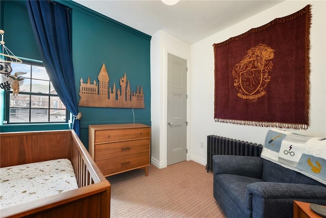 carpeted bedroom featuring baseboards and radiator heating unit