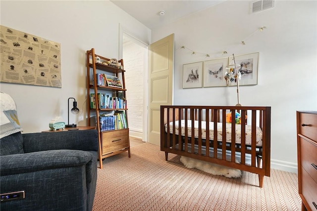 carpeted bedroom featuring visible vents and baseboards