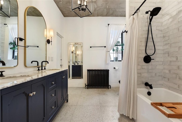 full bath featuring radiator heating unit, shower / bath combo, a sink, and speckled floor