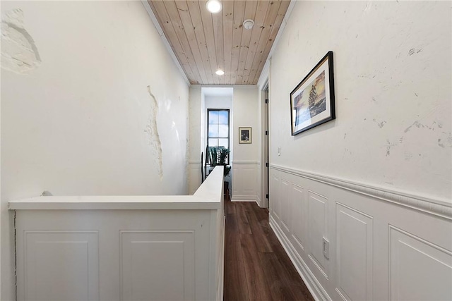 hallway with recessed lighting, wood ceiling, wainscoting, and dark wood-style flooring