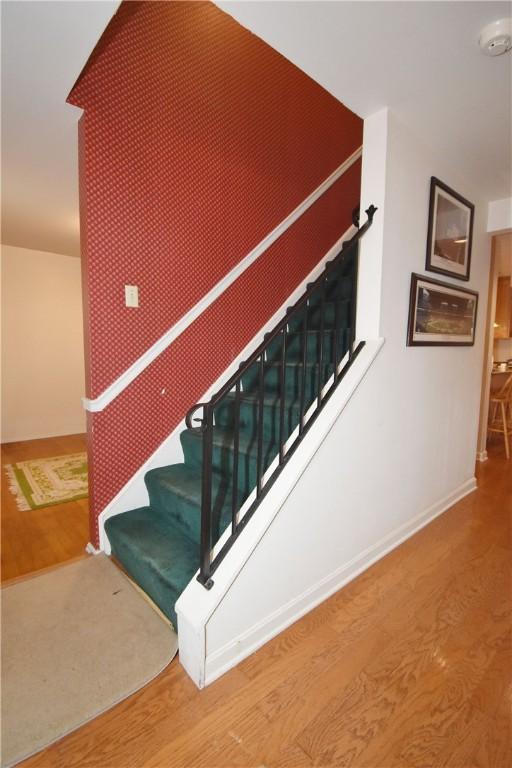 stairs featuring baseboards and wood finished floors