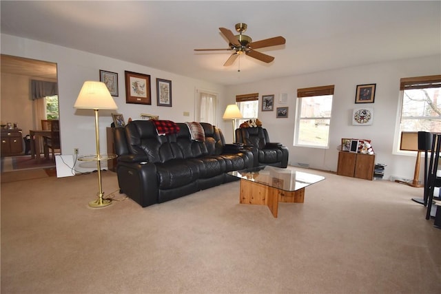 living room with carpet floors, a wealth of natural light, and ceiling fan