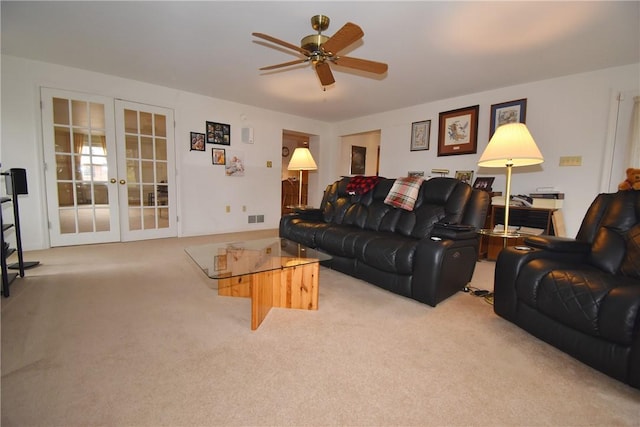 carpeted living room featuring visible vents, a ceiling fan, and french doors