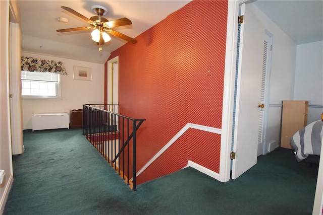 hall featuring carpet and an upstairs landing