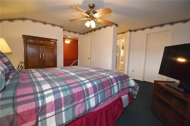 carpeted bedroom with a ceiling fan and connected bathroom