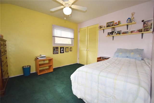 bedroom with ceiling fan, dark colored carpet, and a closet