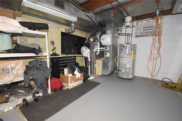 interior space with heating unit, water heater, and concrete block wall