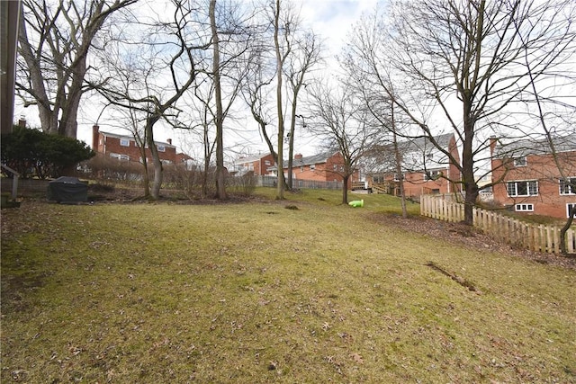 view of yard featuring a residential view and fence