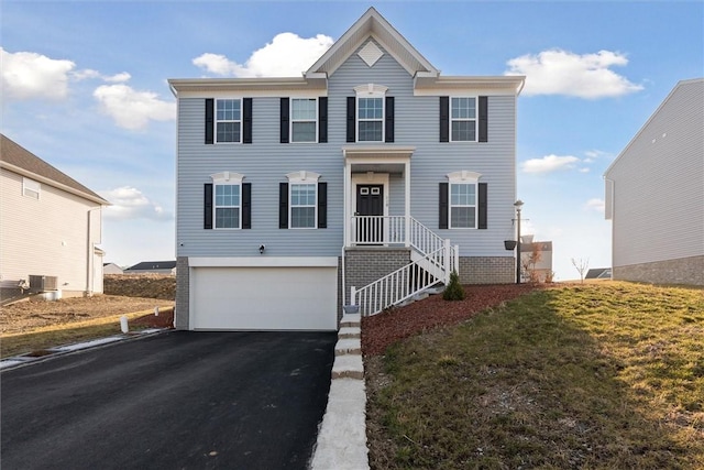 view of front facade with cooling unit, an attached garage, and driveway