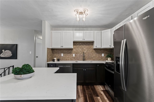 kitchen featuring white cabinets, stainless steel fridge with ice dispenser, dishwashing machine, light countertops, and a sink