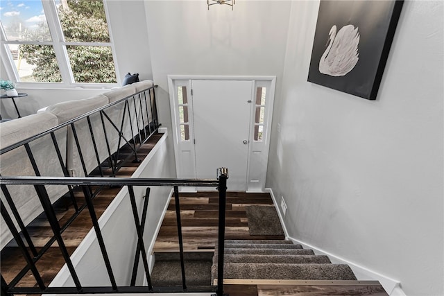 stairway featuring parquet flooring and baseboards