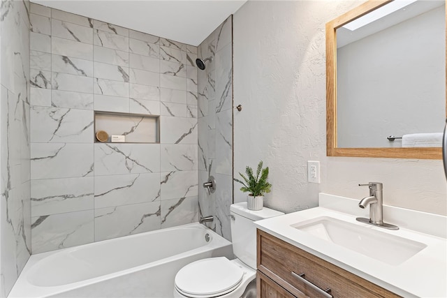 full bath with toilet, shower / tub combination, vanity, and a textured wall