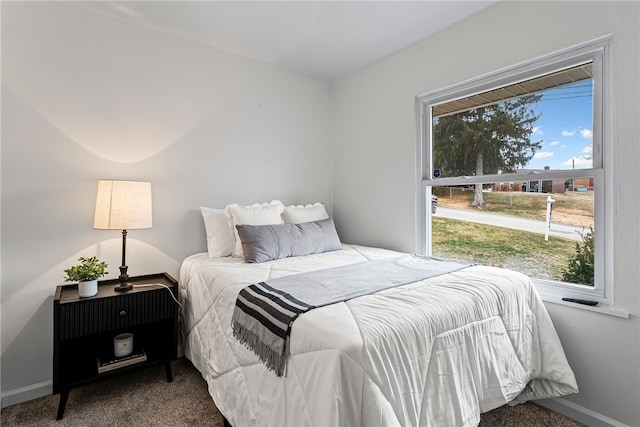 bedroom featuring baseboards and carpet flooring