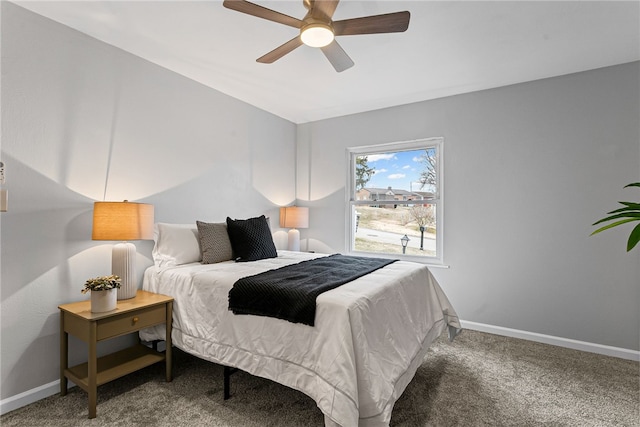 carpeted bedroom featuring baseboards and a ceiling fan