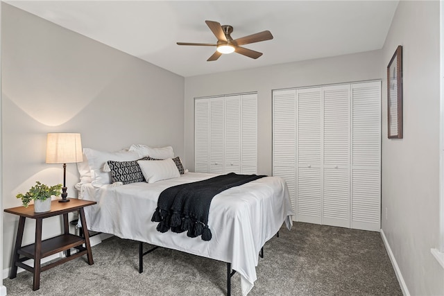 bedroom featuring a ceiling fan, carpet, baseboards, and multiple closets