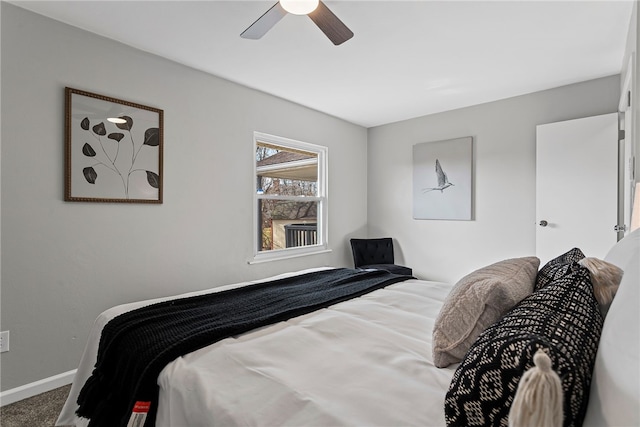 carpeted bedroom featuring ceiling fan and baseboards