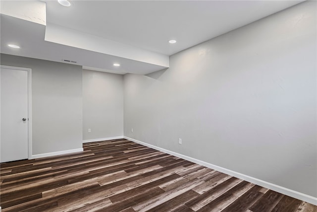 finished below grade area with recessed lighting, visible vents, dark wood finished floors, and baseboards