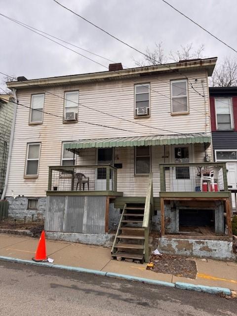 townhome / multi-family property featuring stairway and cooling unit