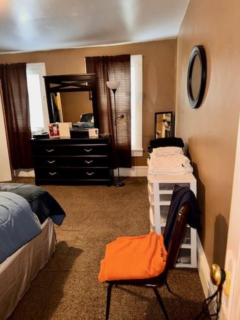 bedroom with carpet floors and baseboards