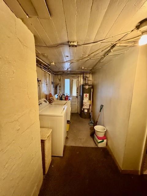 basement with water heater and separate washer and dryer