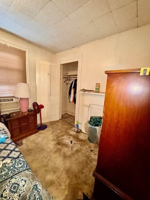 bedroom featuring concrete flooring and a closet