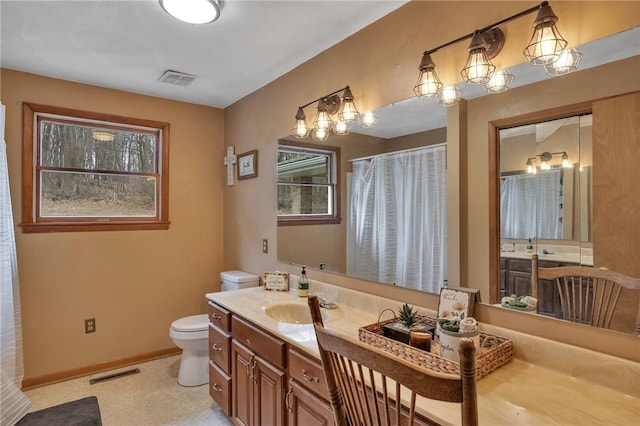 bathroom featuring toilet, baseboards, visible vents, and vanity