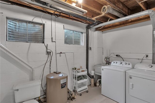 clothes washing area featuring laundry area, independent washer and dryer, and a sink