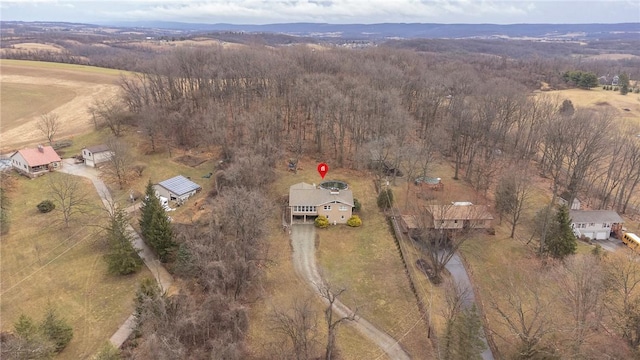 birds eye view of property with a rural view and a view of trees